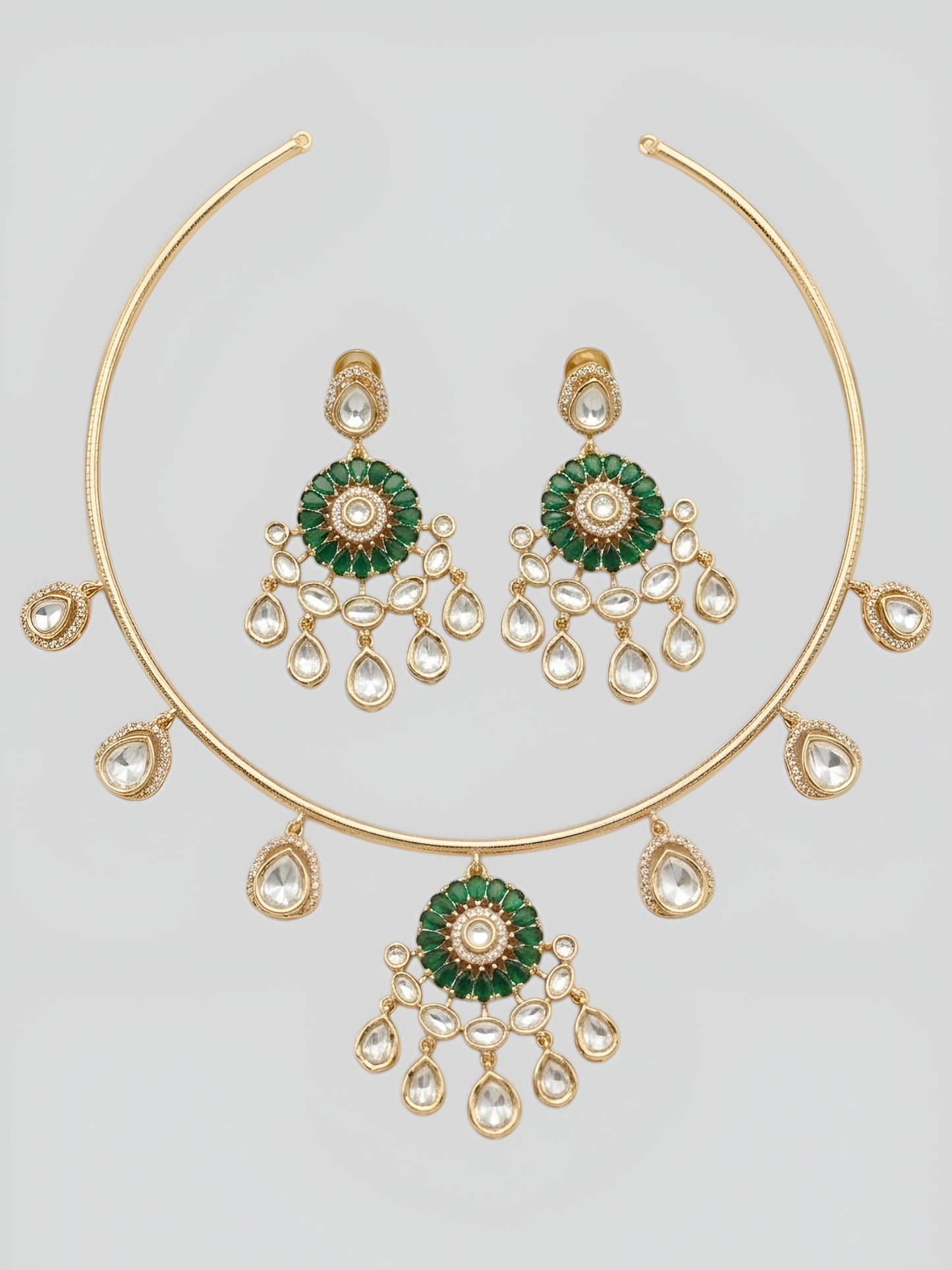 Gold plated choker necklace set with green stones and kundan detailing, featuring matching earrings and teardrop hanging design