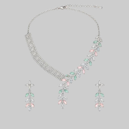 Elegant leaf design American diamond necklace with green stone detailing and matching earrings on red velvet display stand