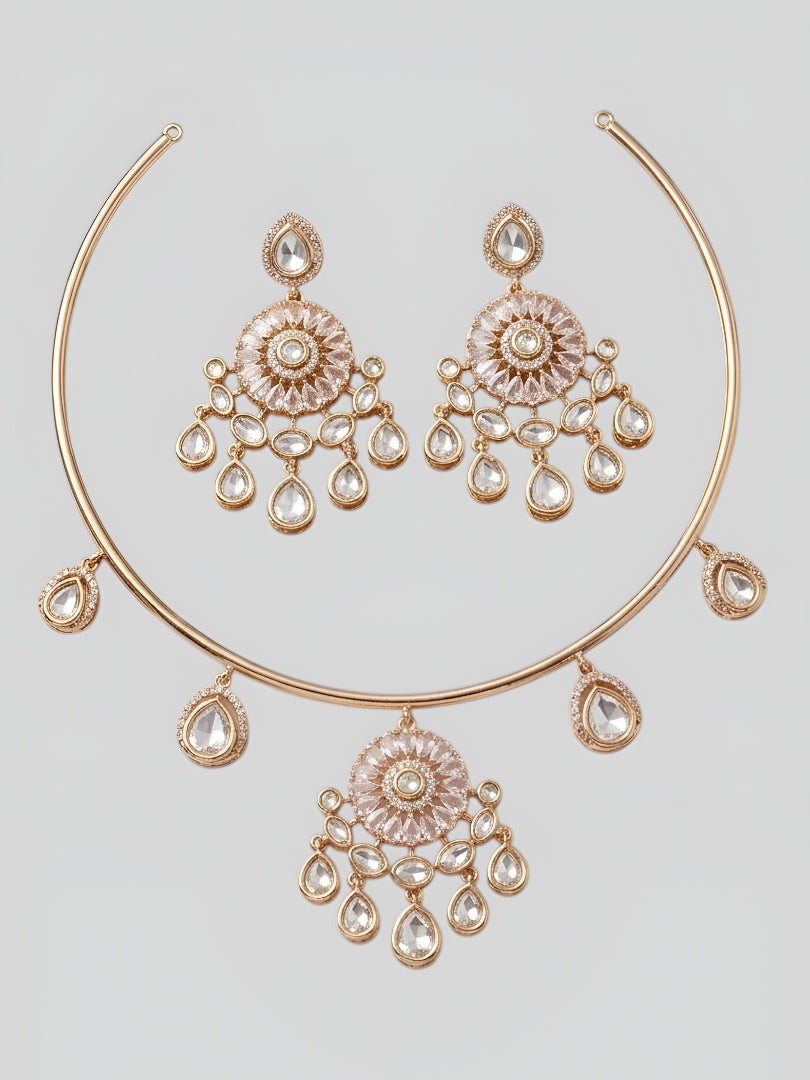 Rose gold plated kundan choker necklace set with crystal teardrop danglers and matching earrings displayed on elegant marble background