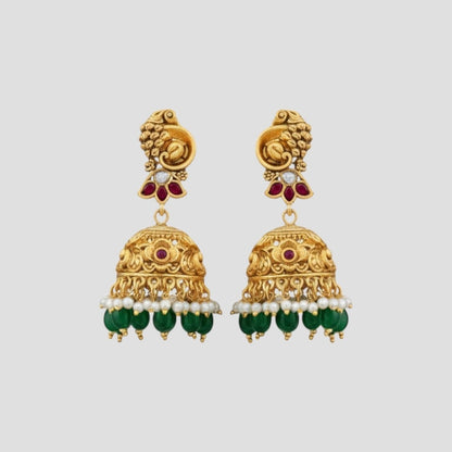 “Gold-plated South Indian temple necklace set with ruby stones, green beads, pearl detailing and matching jhumka earrings.”