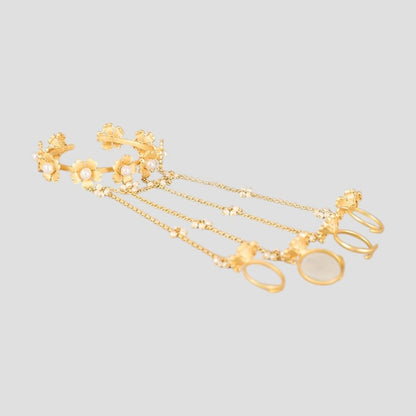 Gold-tone floral pearl hathphool hand harness set with bracelets connected to multiple rings by delicate chains.”