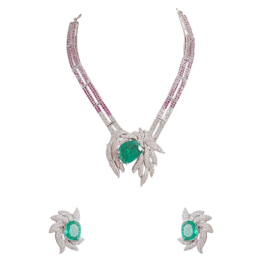 Emerald and diamond leaf design necklace and earrings set with ruby-pink accents on silver base – luxury women’s jewelry set