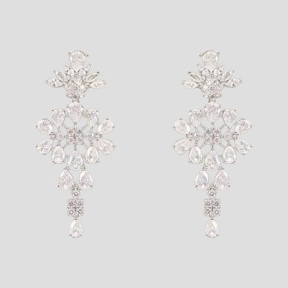 “Silver-tone crystal necklace with matching dangling earrings featuring floral and teardrop stone design.”