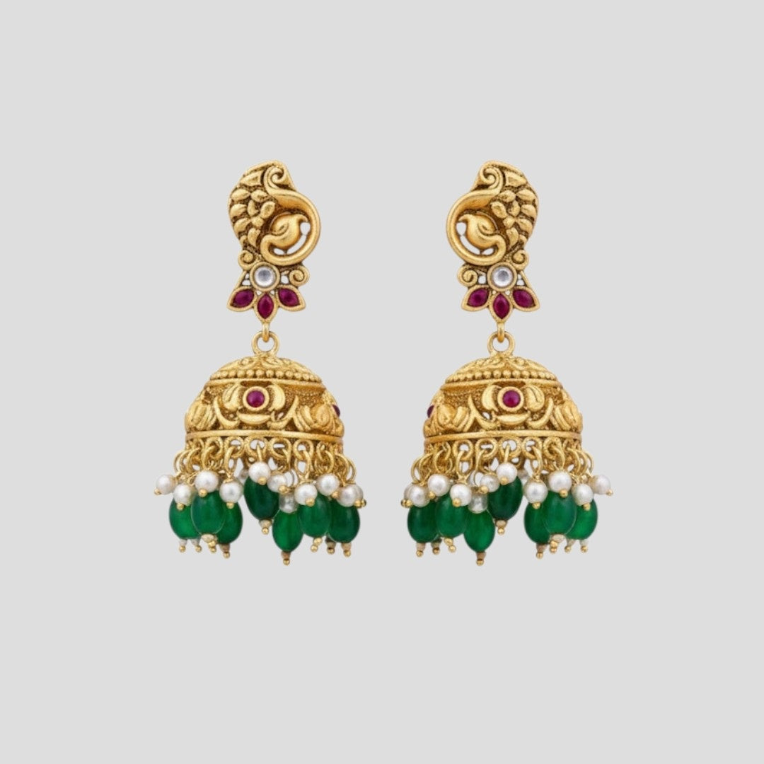 “Antique gold-plated temple necklace set with Lakshmi design, ruby stones, green beads, and matching jhumka earrings.”