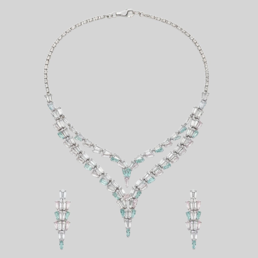 Elegant American Diamond necklace set displayed on a red velvet stand, featuring a double-layered V-shaped necklace with matching earrings, perfect for bridal or party wear.
