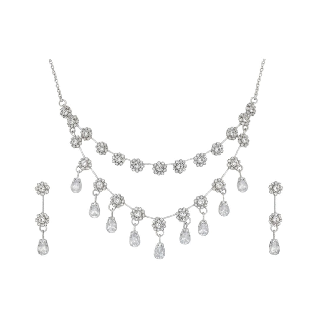 Elegant floral necklace set with matching earrings, silver-plated with crystal details.