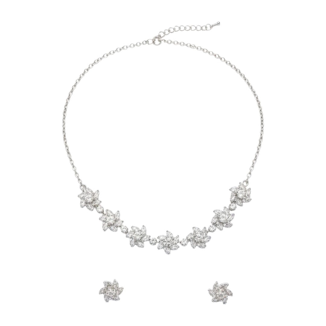 Sparkling floral American diamond necklace with matching earrings displayed on red velvet stand