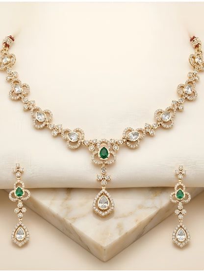 Gold-plated necklace set featuring green stones, American diamonds, floral motifs, and matching drop earrings for women.