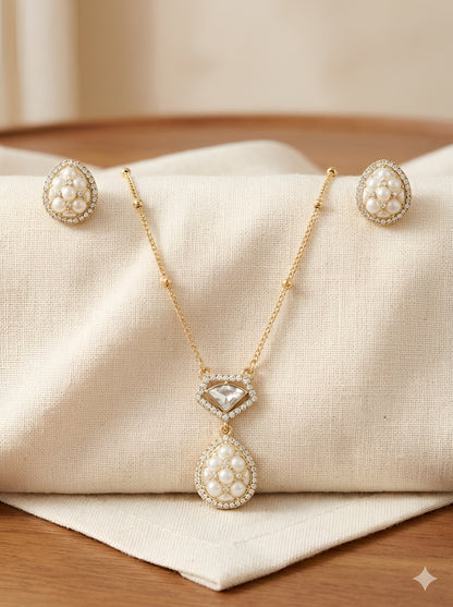 Gold-plated pearl teardrop pendant necklace set with matching stud earrings embellished with American diamonds for women.