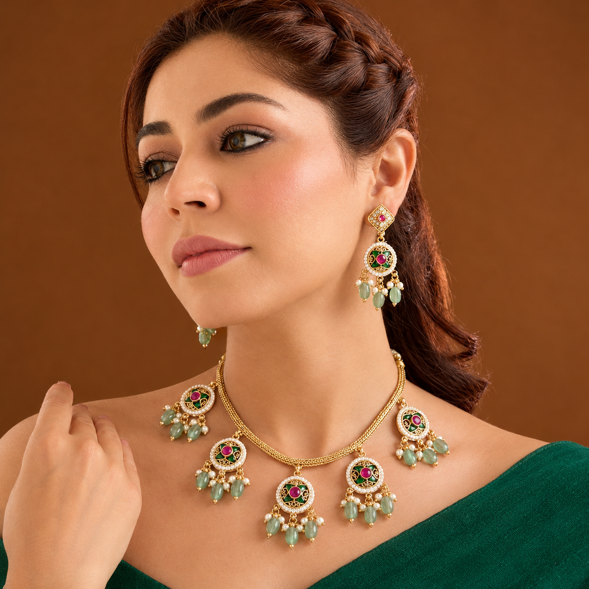 Antique gold plated choker necklace set with ruby pink medallions, mint green bead and pearl drops and matching earrings on a blue bust
