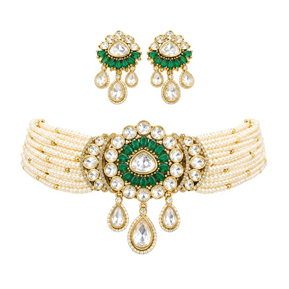 Green kundan pearl choker necklace set with floral centre pendant, kundan teardrop drops and matching floral earrings on a grey display bust