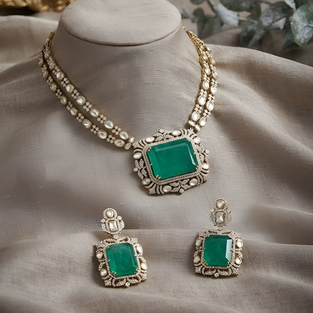 "Antique gold double-strand necklace with large emerald-cut pendant and polki stone detailing, matching drop earrings"