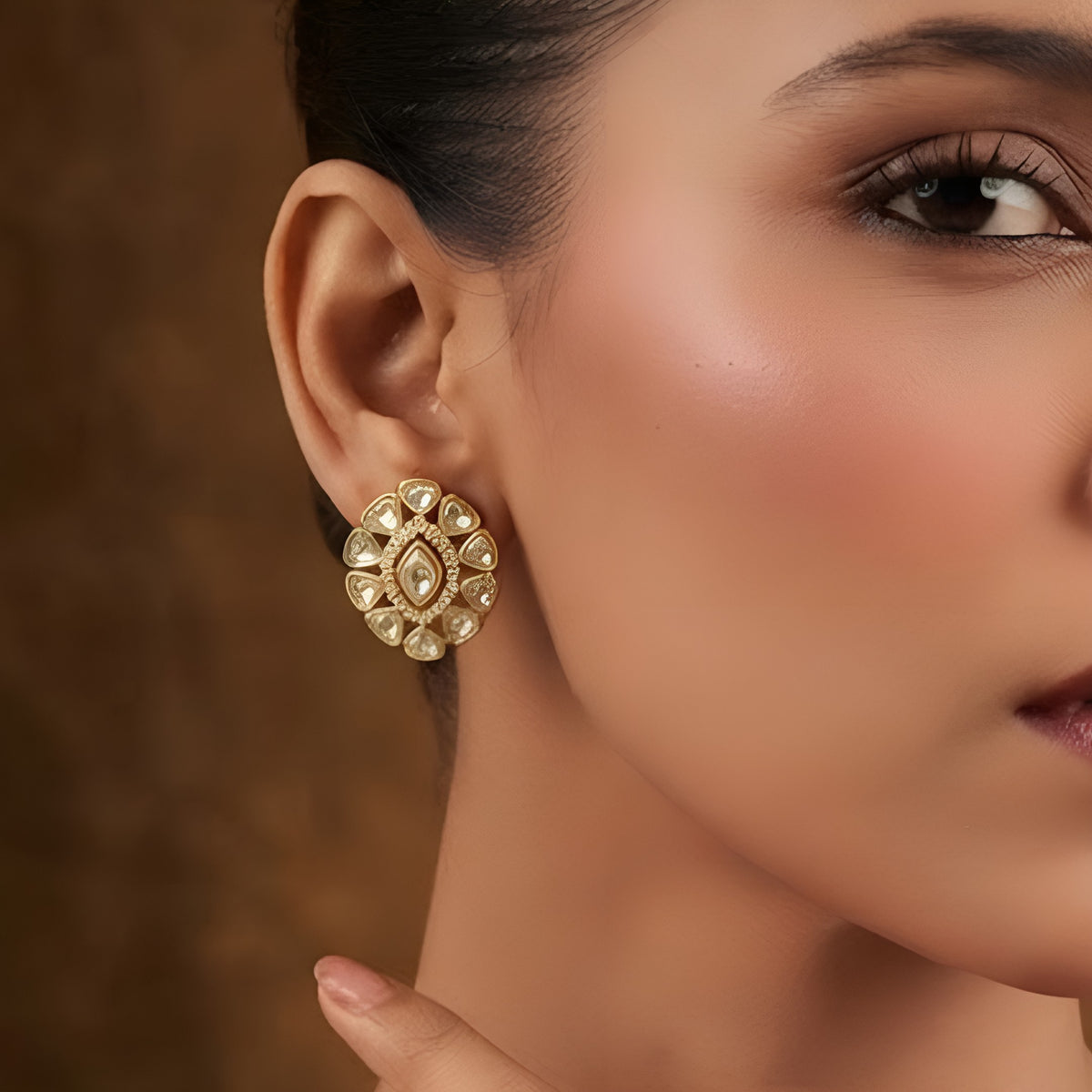 Pair of gold finish kundan polki stud earrings with clear centre stone and zircon halo