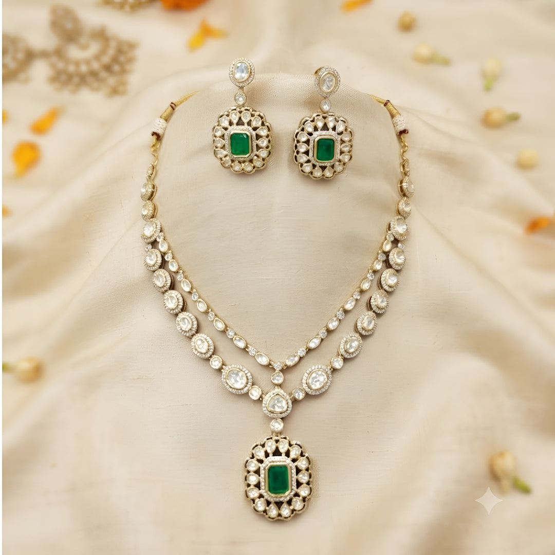 Double layer kundan necklace set with emerald-green pendant and matching kundan drop earrings
