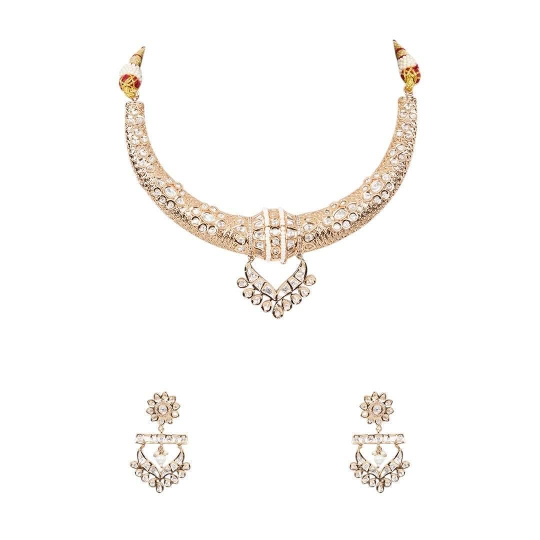 Gold-tone American Diamond designer necklace with textured stone detailing, statement pendant, and matching drop earrings styled on a model.