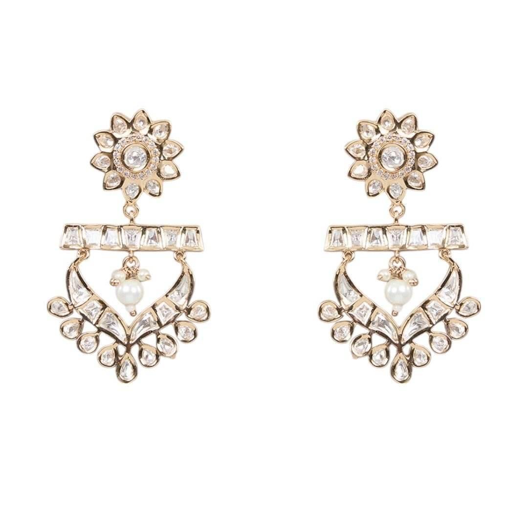 Gold-tone American Diamond designer necklace with textured stone detailing, statement pendant, and matching drop earrings styled on a model.