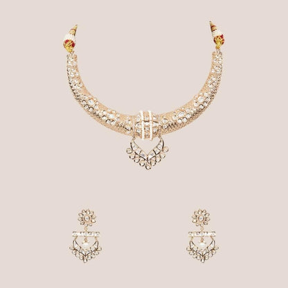 Gold-tone American Diamond designer necklace with textured stone detailing, statement pendant, and matching drop earrings styled on a model.