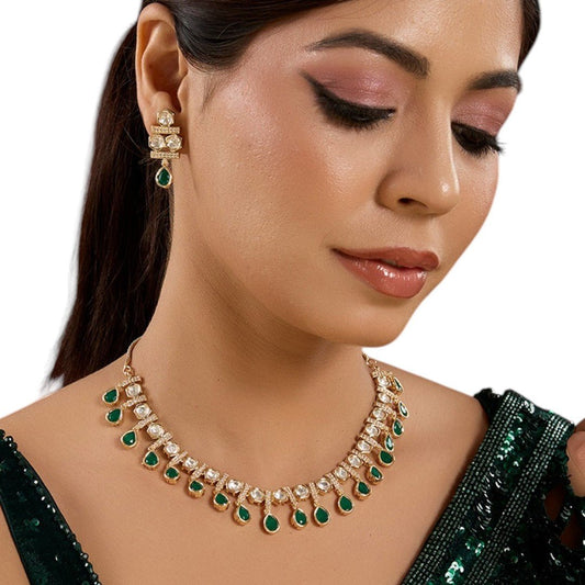 Classic Green Stone Kundan Necklace Set with Earrings - Auraa Trends - necklace -  - Auraa Trends - Woman wearing a gold - toned kundan necklace with green teardrop stones and white kundan details, along with earrings in matching