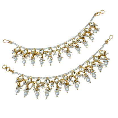 Classic Pearl & Golden Kundan Single Layer Kaan Chain - Auraa Trends - Kaan chain -  - Auraa Trends - Elegant golden Kundan and pearl single - layer Kaan Chain (Ear Chain) with heart - shaped motifs and dangling pearl drops, displayed on a beige fabric background with decorative flowers and seashell.