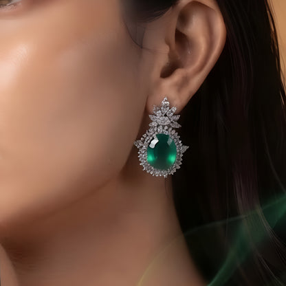 Rhodium plated emerald green oval stud earrings with marquise CZ floral crown halo design