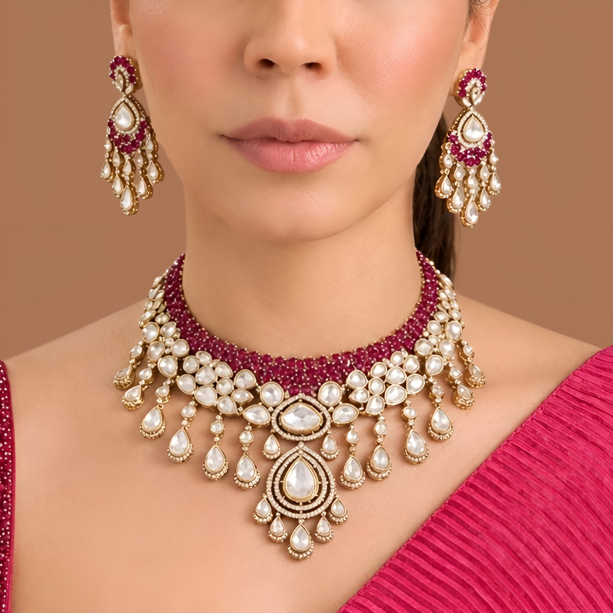 Gold kundan polki ruby red bridal choker necklace set with teardrop fringe and matching chandelier earrings by Auraa Trends