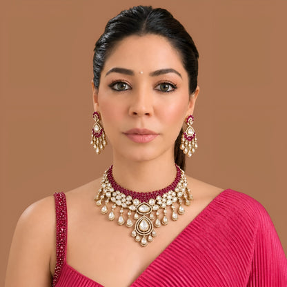 Gold kundan polki ruby red bridal choker necklace set with teardrop fringe and matching chandelier earrings by Auraa Trends