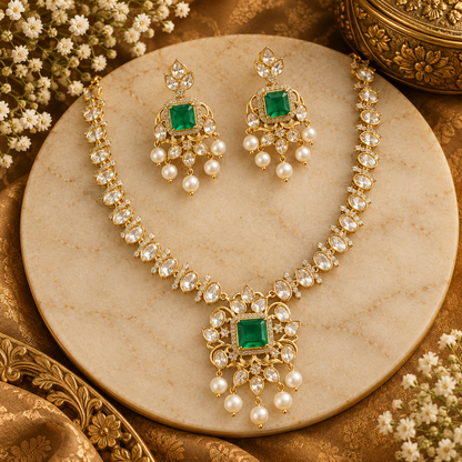 Gold finish kundan polki necklace set with emerald green square stone pendant and pearl drops