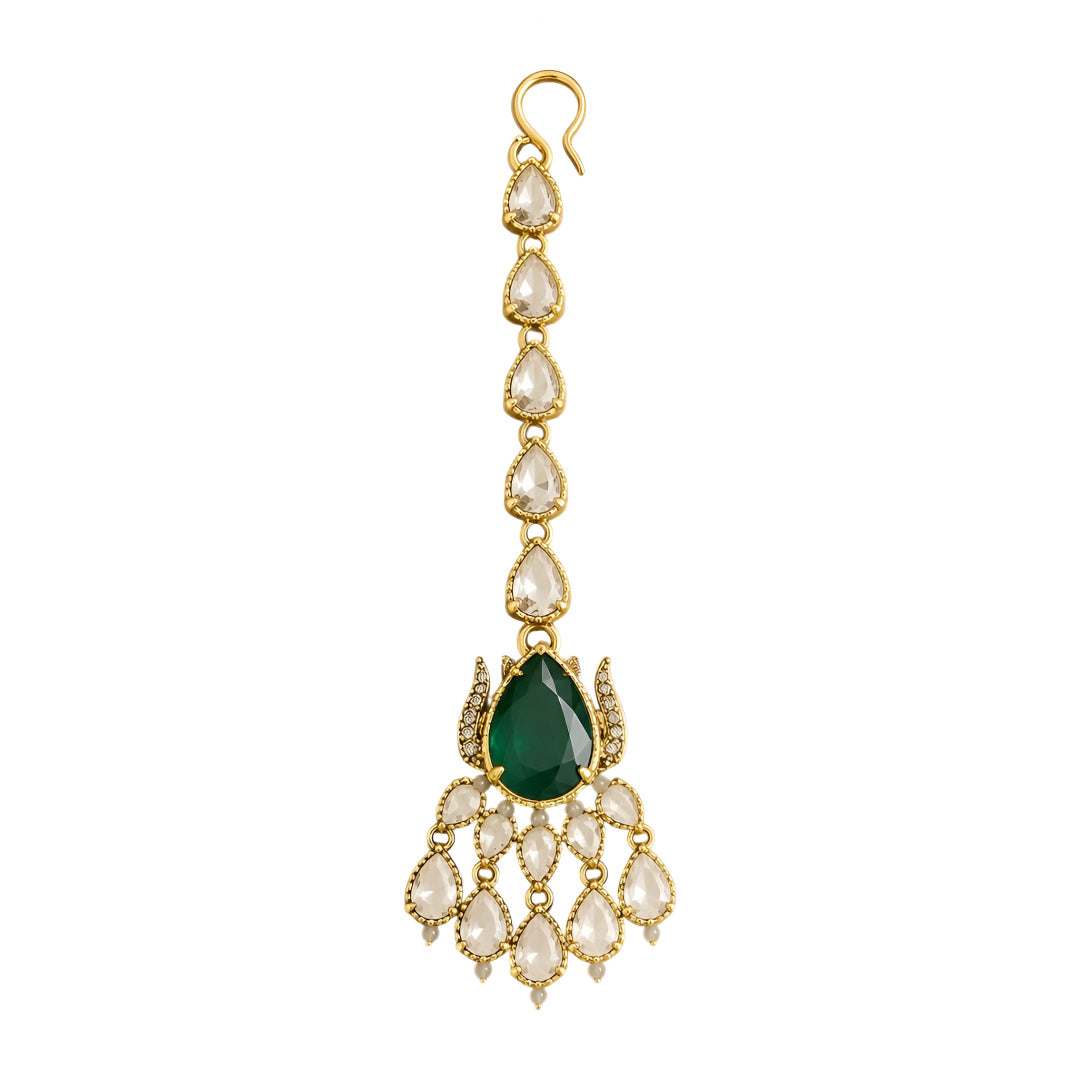 Gold maang tikka with pear-cut emerald green stone and clear kundan crystal chain, Indian bridal hair jewelry on white background