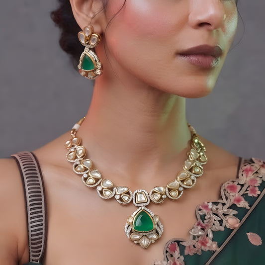Green kundan pendant necklace set with emerald triangular stone, kundan petals and matching drop earrings