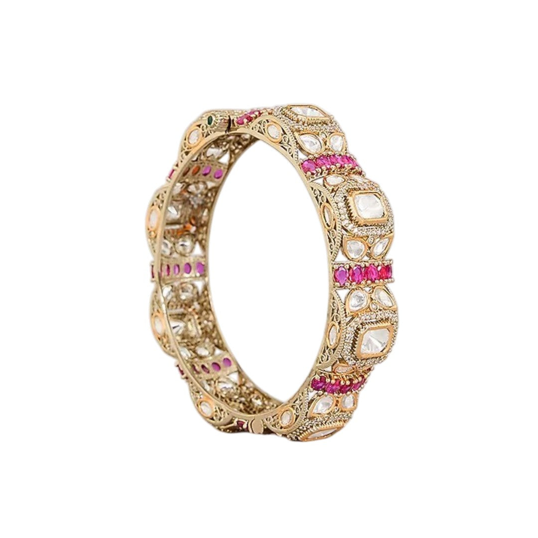 "Set of two gold-toned bangles with white polki stones and ruby-pink stone clusters, traditional Indian bridal jewelry"