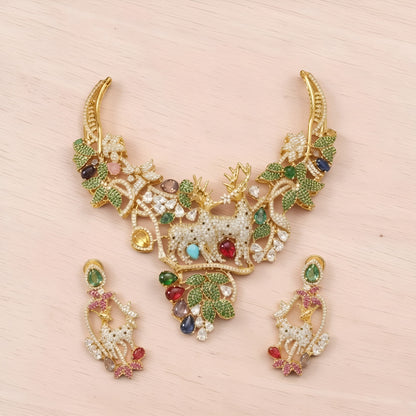 Gold plated deer motif statement necklace with zircon leaves and multicolour stones on a display bust