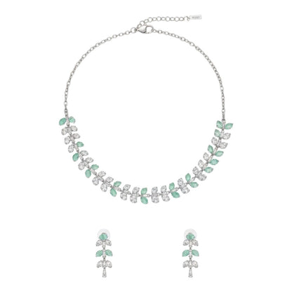 Silver necklace and matching earrings set with green and clear crystals displayed on a red velvet jewelry stand, perfect for weddings and formal events.
