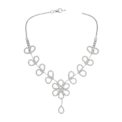 Floral diamond-look necklace set with matching earrings on red display stand