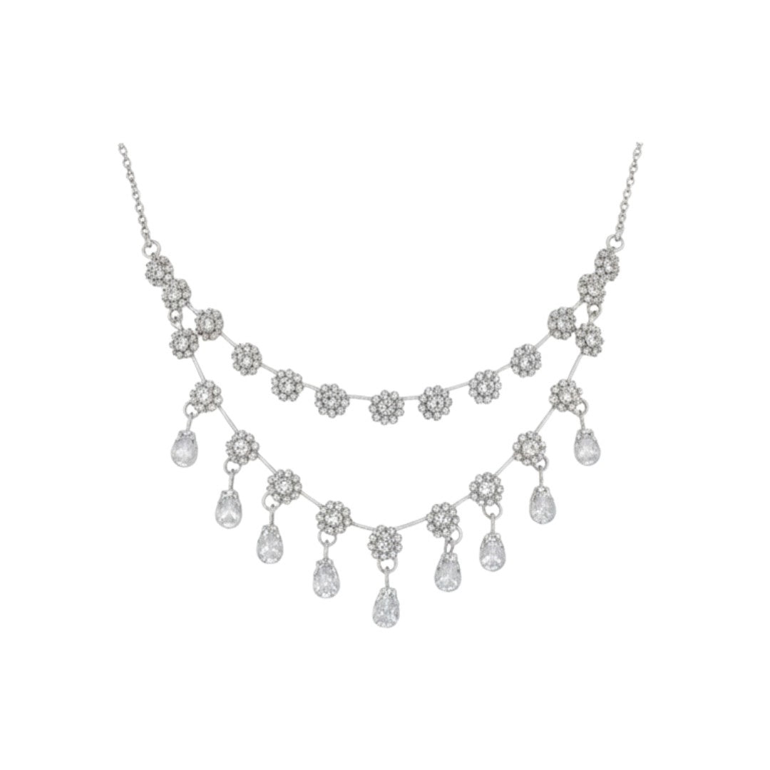 Elegant floral necklace set with matching earrings, silver-plated with crystal details.