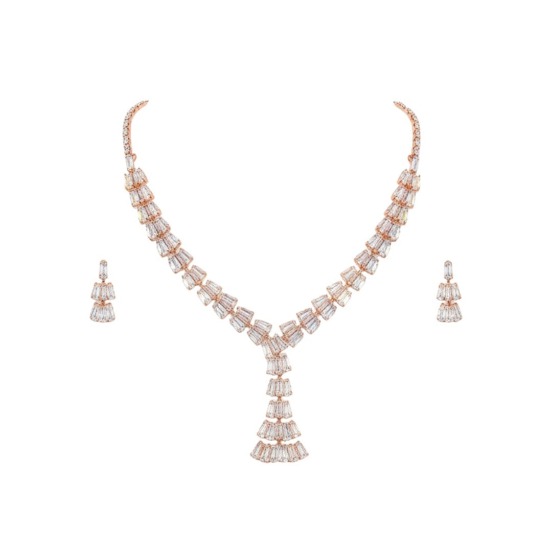 Elegant leaf design American diamond necklace with green stone detailing and matching earrings on red velvet display stand
