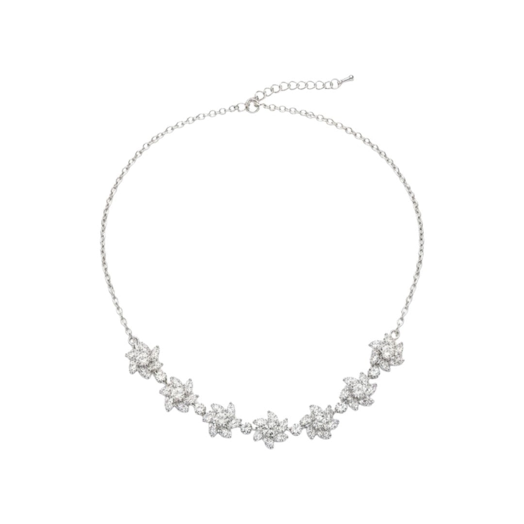 Sparkling floral American diamond necklace with matching earrings displayed on red velvet stand