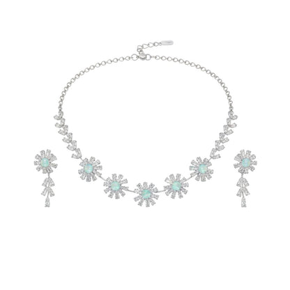 Elegant floral necklace and earrings set with green gemstone and sparkling American diamonds on red display stand