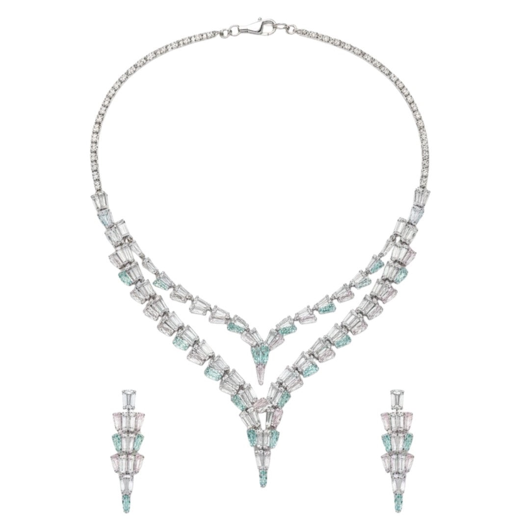 Elegant American Diamond necklace set displayed on a red velvet stand, featuring a double-layered V-shaped necklace with matching earrings, perfect for bridal or party wear.