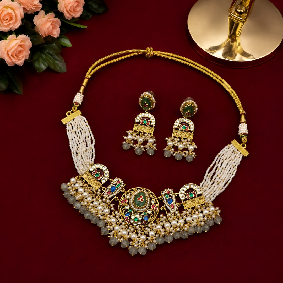 "Antique gold multi-strand pearl beaded necklace and earring set with meenakari enamel work and grey bead drops, temple jewellery on maroon backdrop"