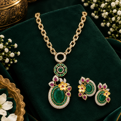 Gold-tone American diamond link chain necklace with a large oval emerald-green flower pendant and matching earring on a grey display bust