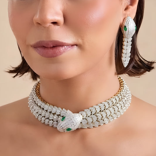Rhodium-plated snake-inspired necklace set with green and white stones and matching earrings