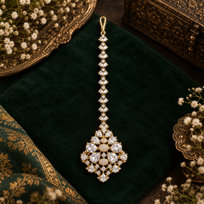 Gold finish American diamond maang tikka with clear pear-cut zircon stones, pave zircon accents and a leaf-shaped zircon chain – Auraa Trends