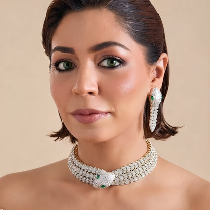 Rhodium-plated snake-inspired necklace set with green and white stones and matching earrings