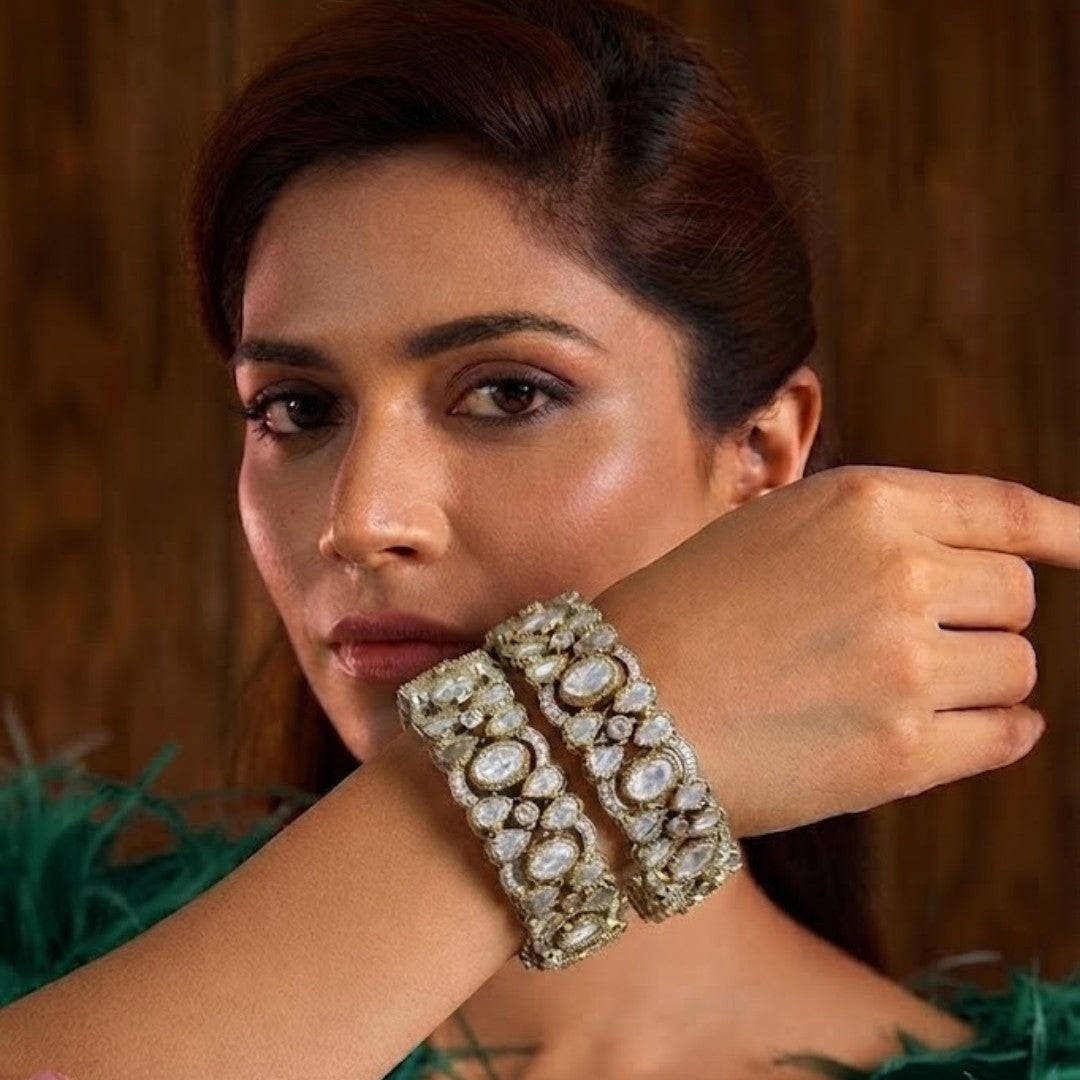"Pair of wide gold-plated bridal bangles with bezel-set white crystals in openwork design"