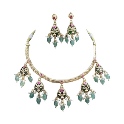 Antique gold plated necklace set with dark green pear medallions, pink stones, mint green bead and pearl drops and matching earrings on a blue bust
