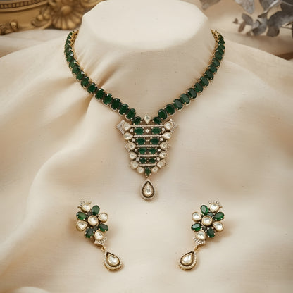 "Emerald green Kundan-style necklace and earring set with antique gold finish and white stone accents"
