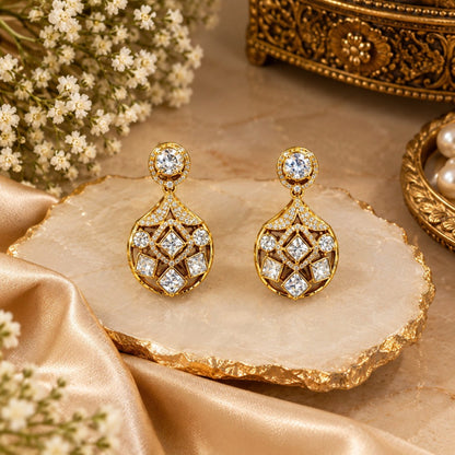 Gold-plated kundan style drop earrings with round halo stud, pavé fan bridge and open teardrop body set with square and round clear zircon stones