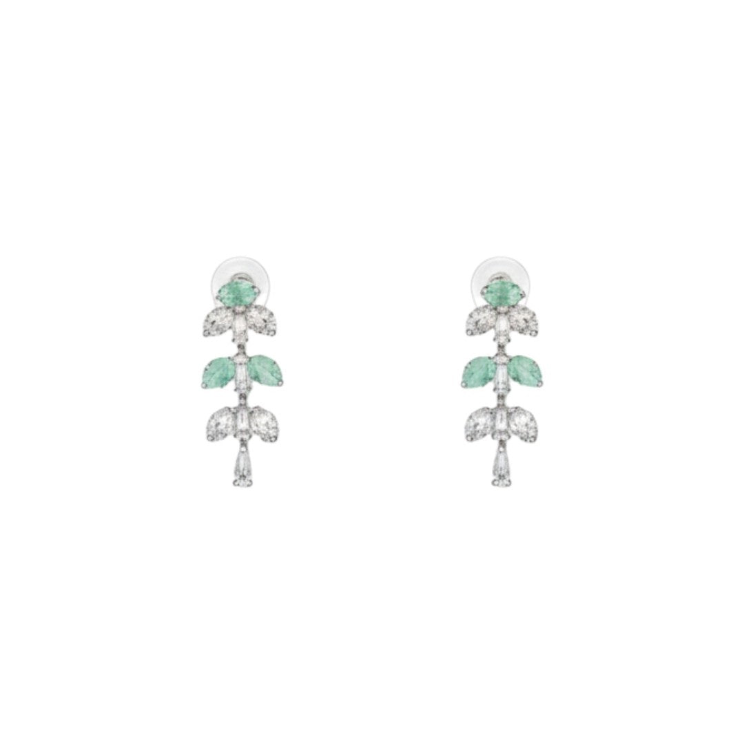 Silver necklace and matching earrings set with green and clear crystals displayed on a red velvet jewelry stand, perfect for weddings and formal events.