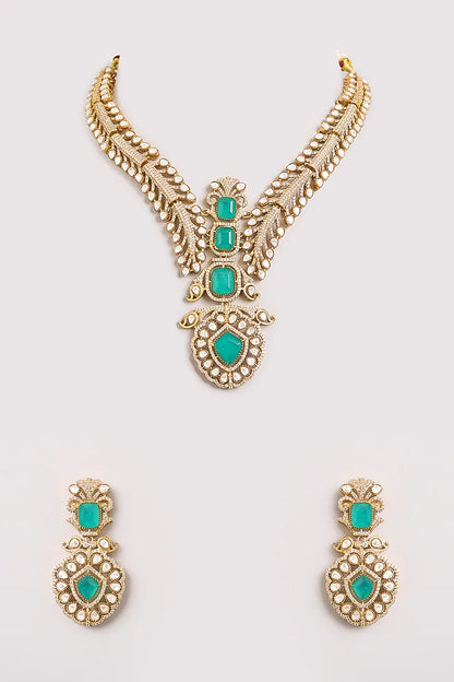 Gold-plated American diamond necklace set with emerald green stones and matching earrings for women, perfect for bridal, wedding, festive, and party wear.