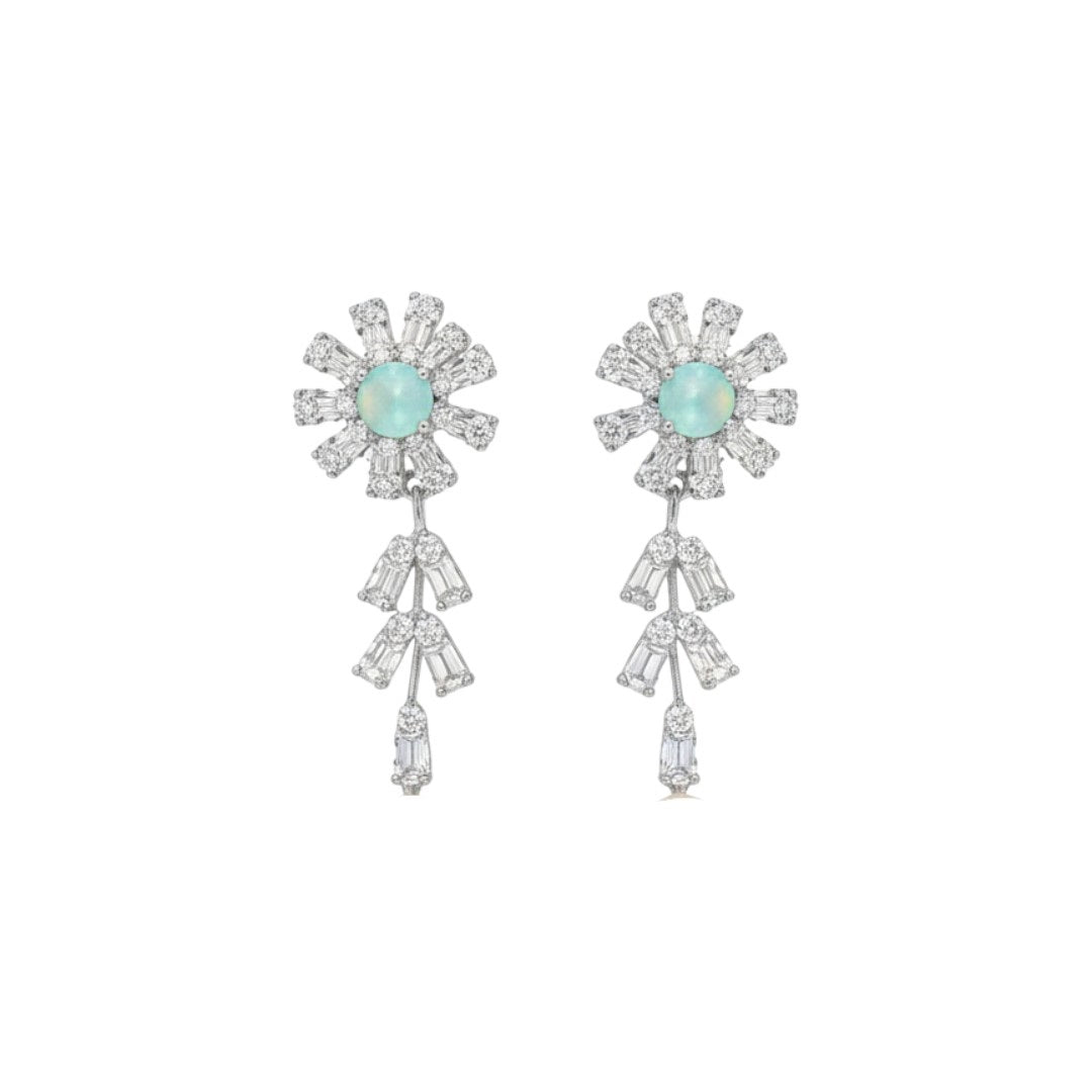 Elegant floral necklace and earrings set with green gemstone and sparkling American diamonds on red display stand